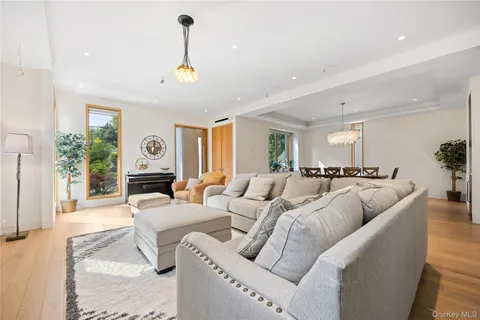 a living room with furniture and a chandelier