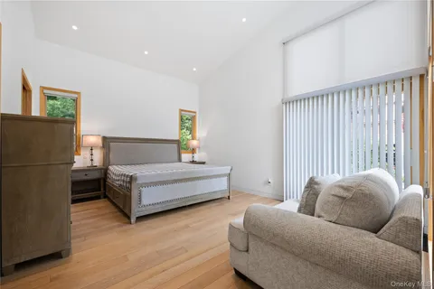 a bedroom with furniture and a wooden floor