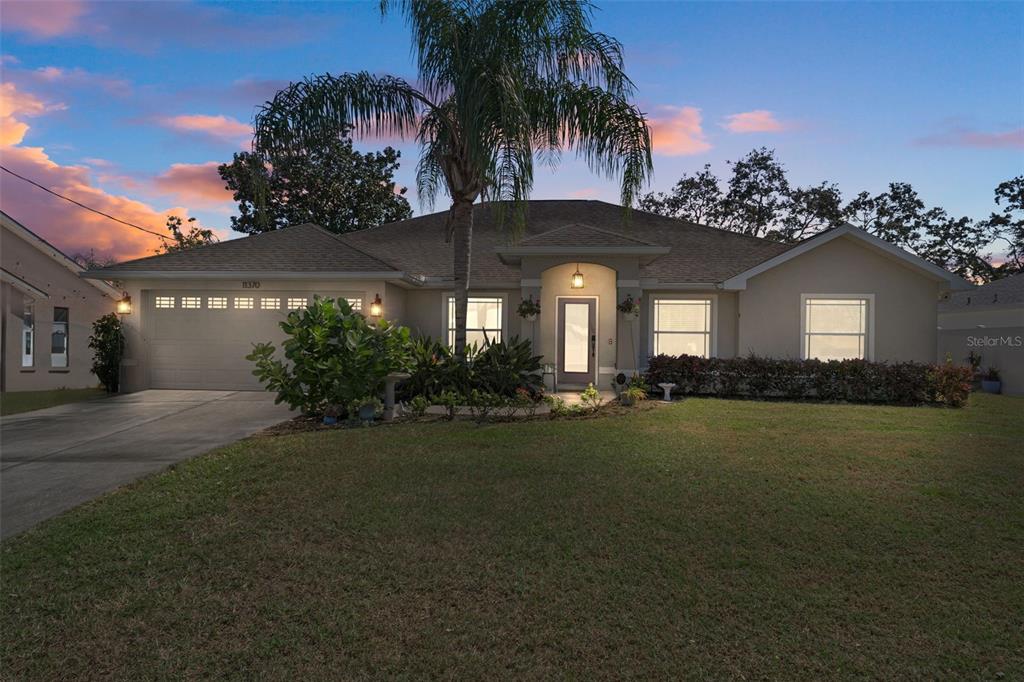 11370 Terrell Road Spring Hill, FL 34608 - Photo 1 of 54 a front view of a house with a garden
