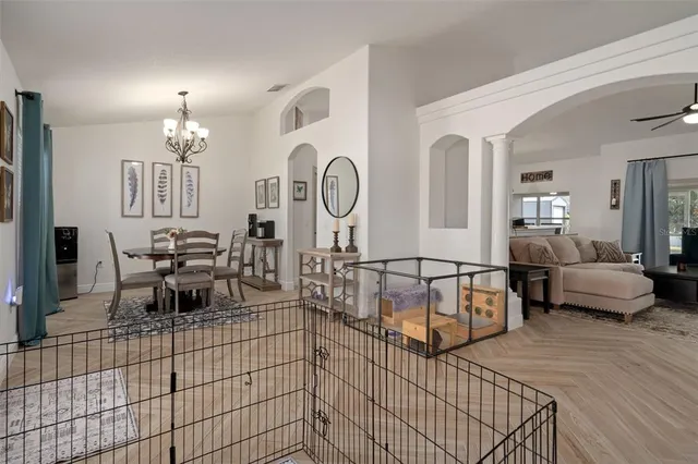 a view of a dining room with furniture and chandelier