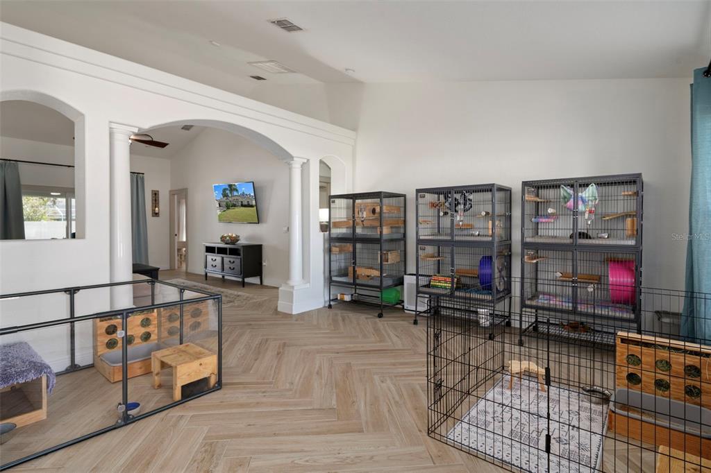 11370 Terrell Road Spring Hill, FL 34608 - Photo 12 of 54 a living room with lots of furniture and white walls