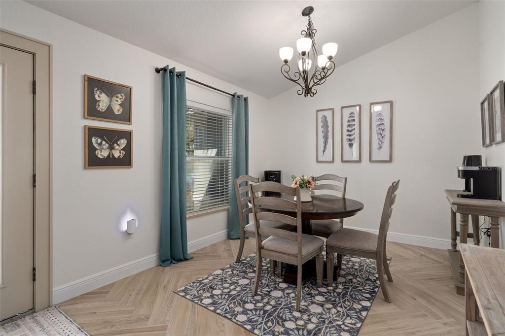 11370 Terrell Road Spring Hill, FL 34608 - Photo 13 of 54 a view of a dining room with furniture and chandelier