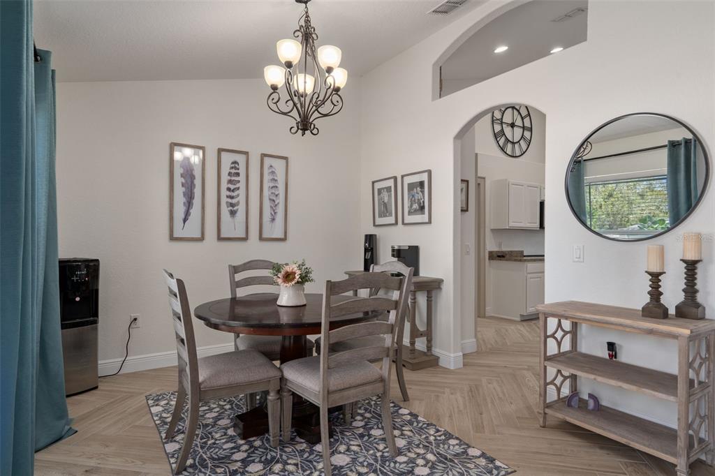 11370 Terrell Road Spring Hill, FL 34608 - Photo 14 of 54 a dining room with furniture and a chandelier
