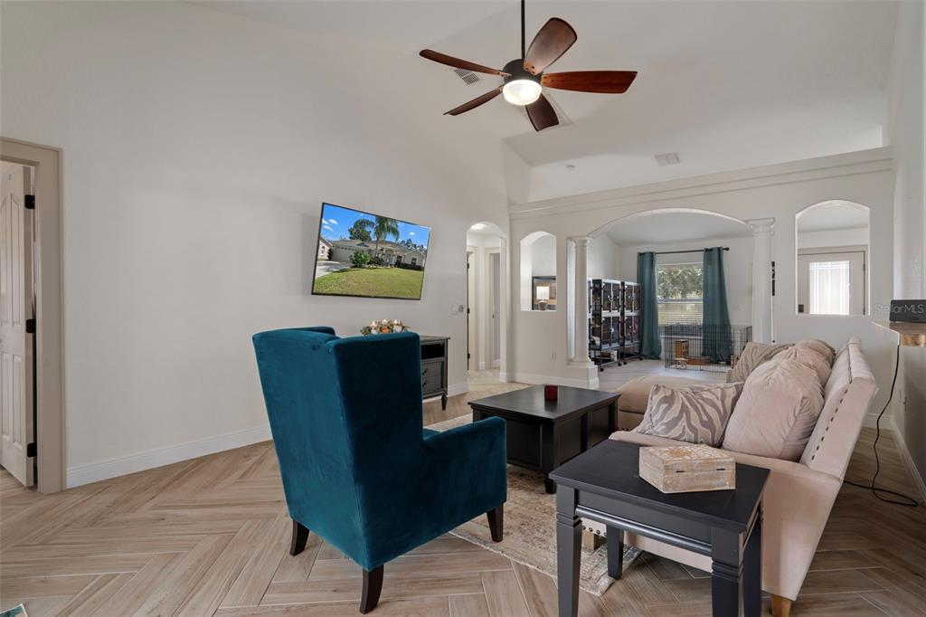 11370 Terrell Road Spring Hill, FL 34608 - Photo 18 of 54 a living room with furniture a ceiling fan a rug and a window
