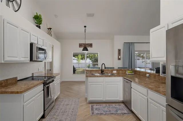 a large kitchen with a table and chairs