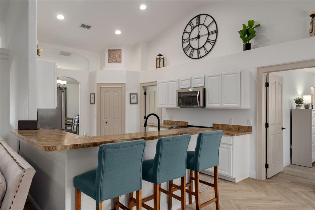 11370 Terrell Road Spring Hill, FL 34608 - Photo 24 of 54 a kitchen with stainless steel appliances granite countertop a table and chairs in it