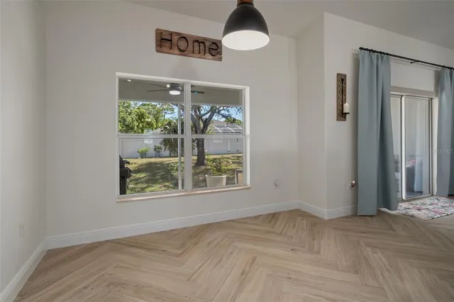 a spacious bedroom with a bed and a flat screen tv