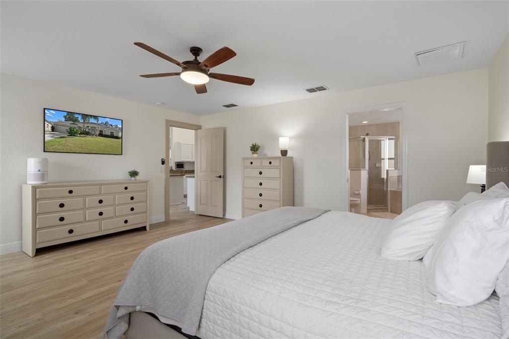 11370 Terrell Road Spring Hill, FL 34608 - Photo 28 of 54 a spacious bedroom with a bed and a flat screen tv