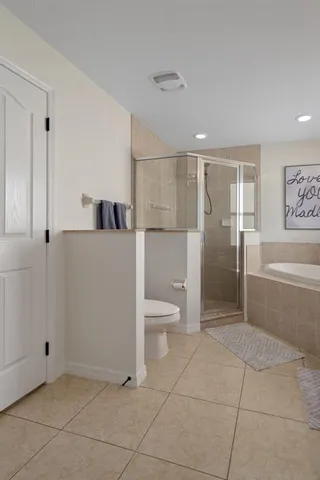 a bathroom with a sink double vanity granite tub shower and a mirror
