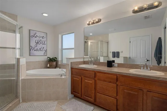a bedroom with a bed and a chandelier fan