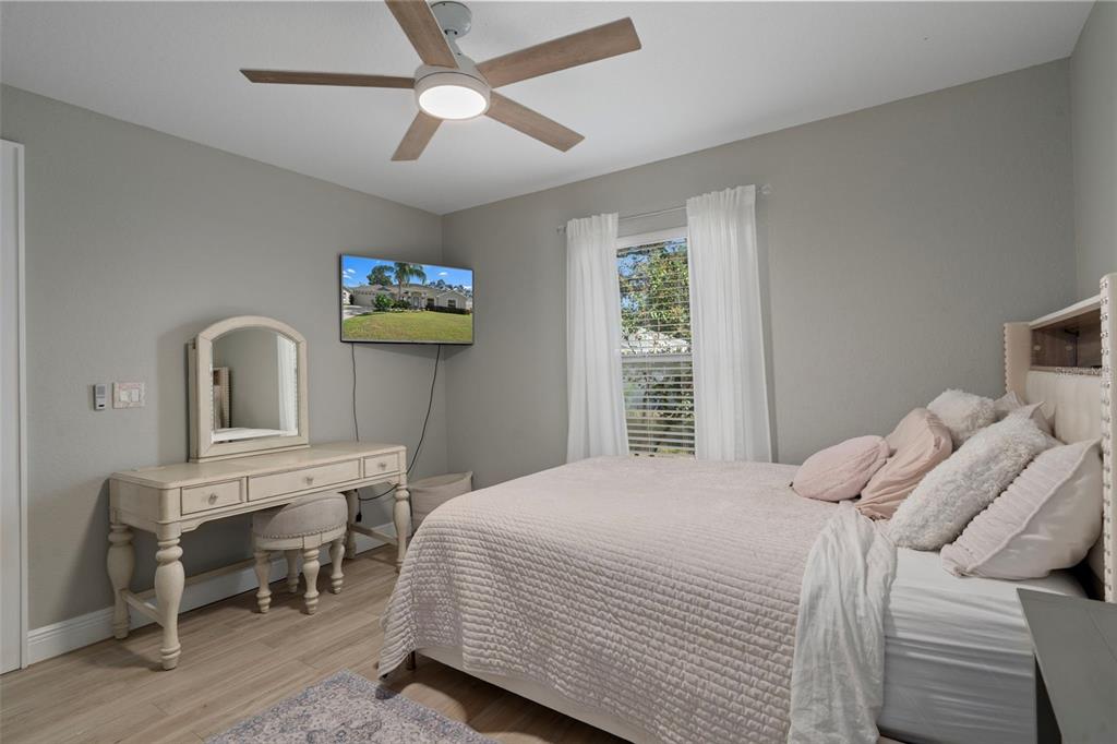 11370 Terrell Road Spring Hill, FL 34608 - Photo 37 of 54 a bedroom with a bed and a flat screen tv