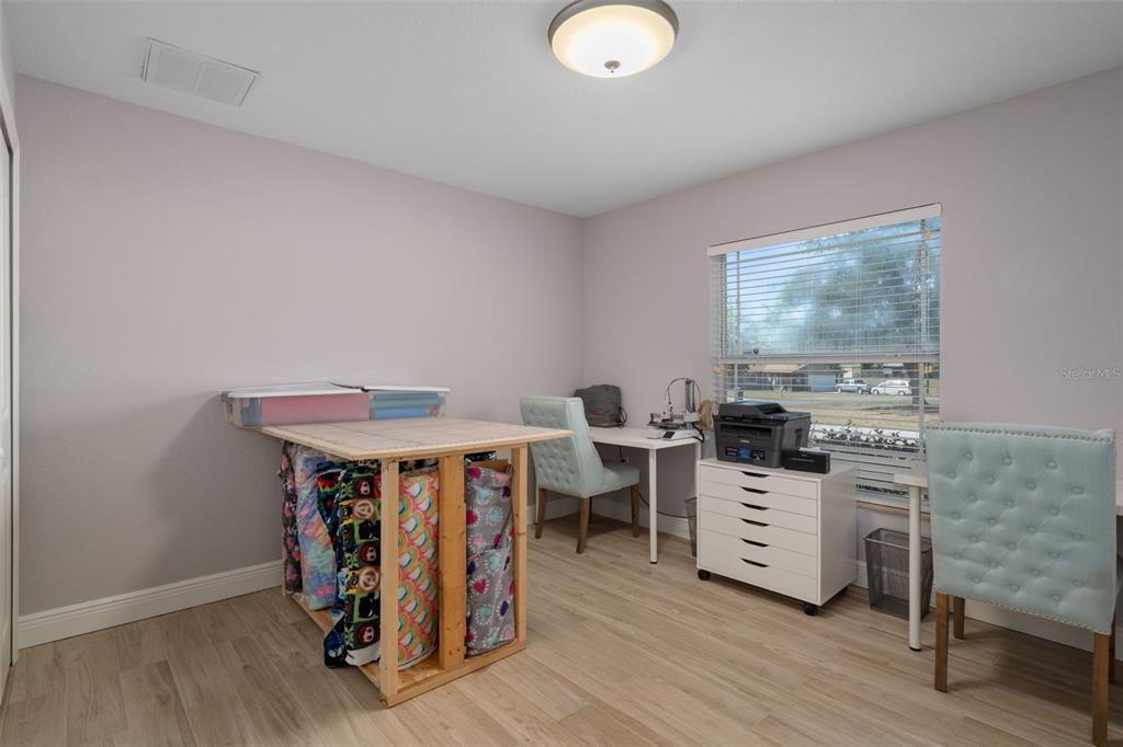 11370 Terrell Road Spring Hill, FL 34608 - Photo 39 of 54 a view of a workspace with furniture and wooden floor