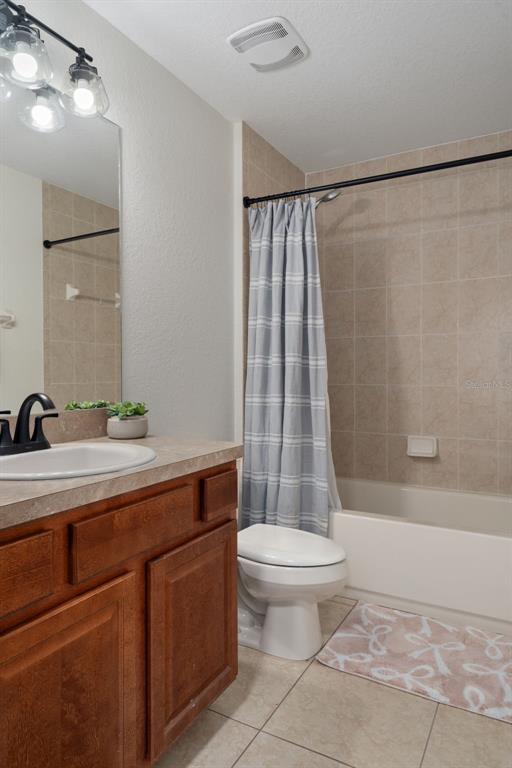 11370 Terrell Road Spring Hill, FL 34608 - Photo 40 of 54 a bathroom with a sink a toilet a mirror and a shower
