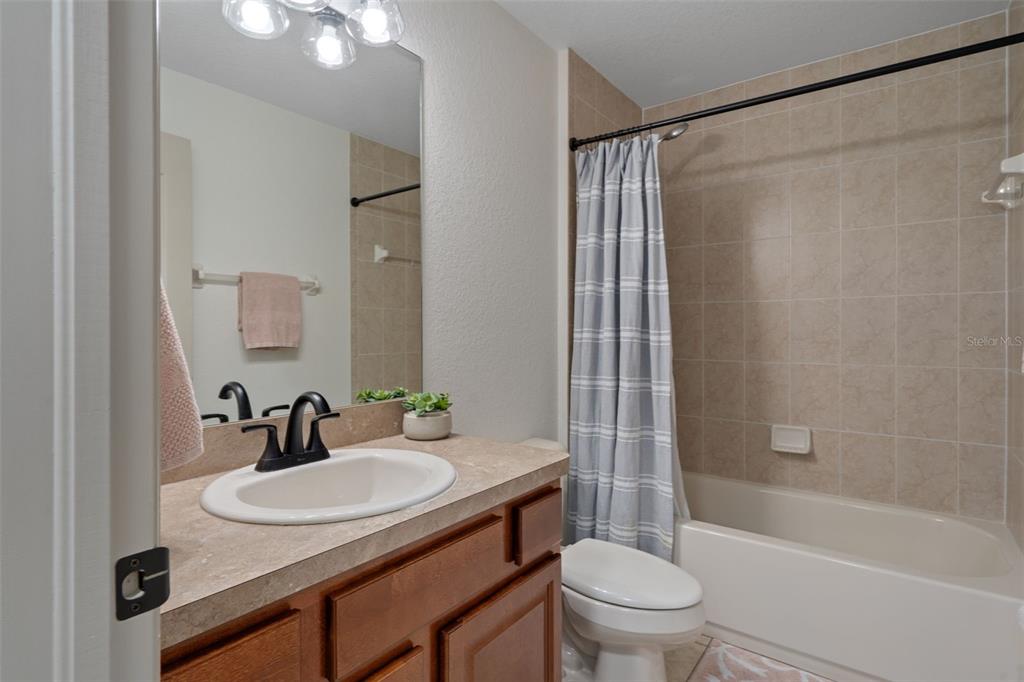 11370 Terrell Road Spring Hill, FL 34608 - Photo 41 of 54 a bathroom with a sink toilet and shower