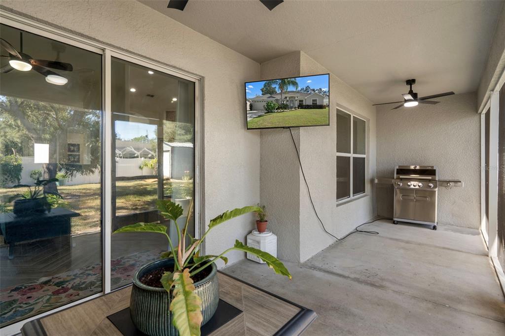 11370 Terrell Road Spring Hill, FL 34608 - Photo 43 of 54 a living room with furniture a floor to ceiling window and stainless steel appliances