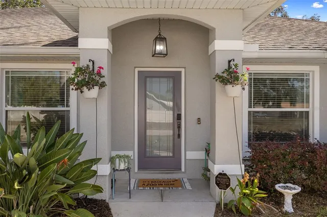 a living room with furniture a flat screen tv and a table