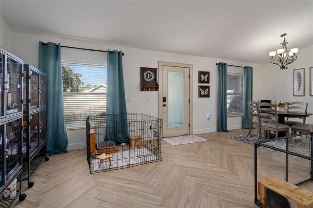 11370 Terrell Road Spring Hill, FL 34608 - Photo 10 of 54 a living room with furniture a flat screen tv and a table