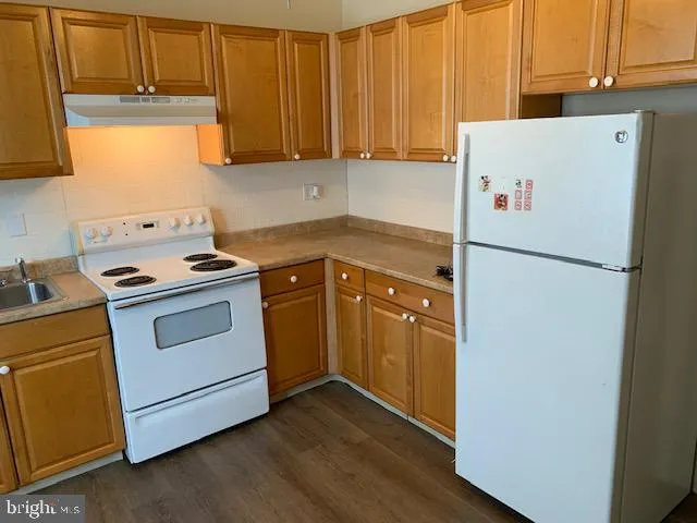 a white refrigerator freezer sitting in a kitchen