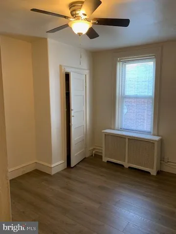 a room with wooden floors and a window