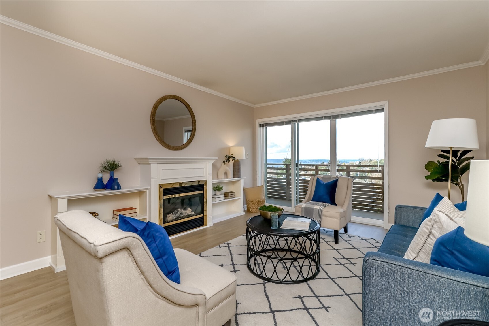 4444 44th Avenue Southwest, Unit 405 Seattle, WA 98116 - Photo 14 of 32 a living room with furniture a fireplace a potted plant and a large window