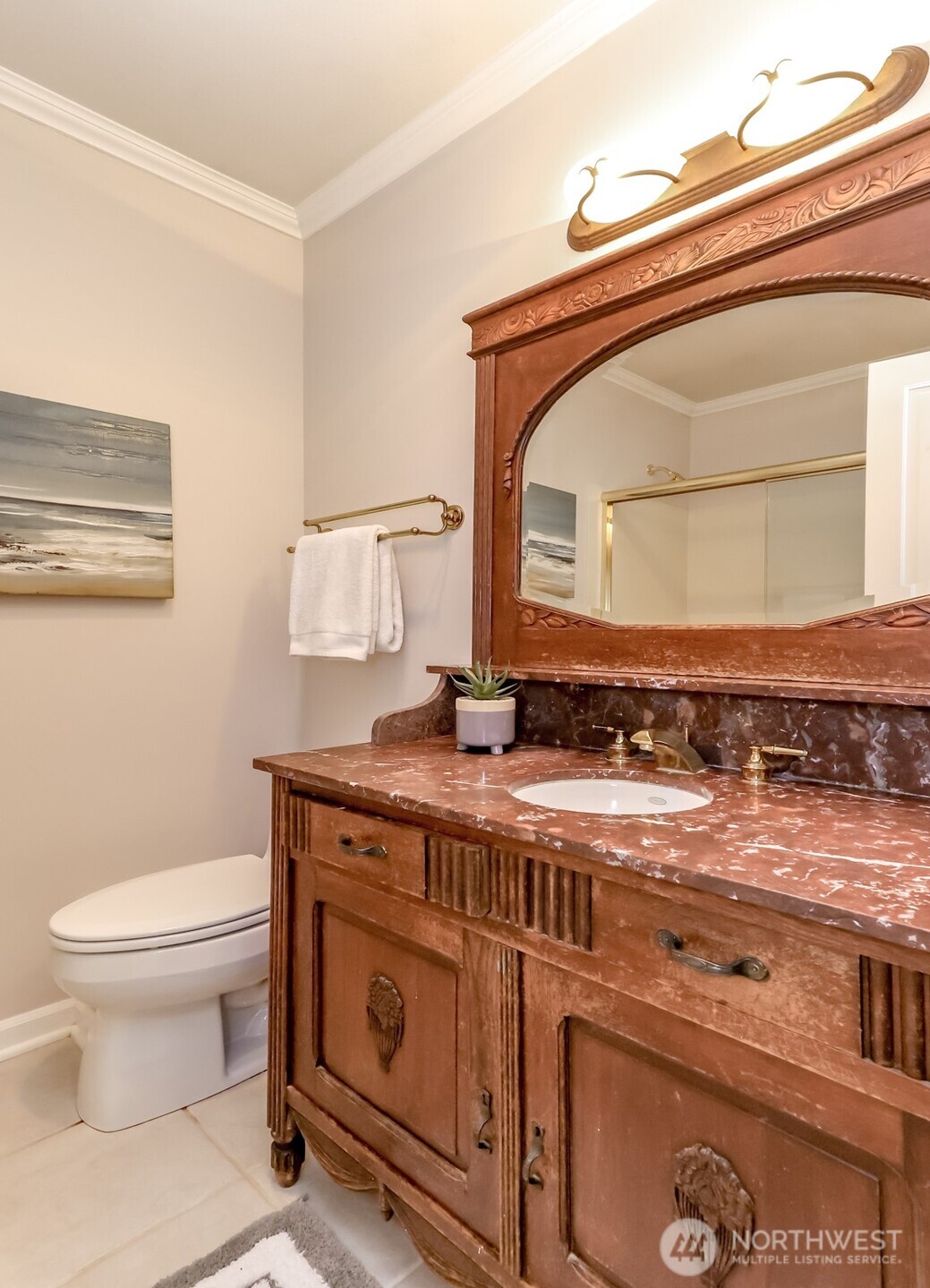 4444 44th Avenue Southwest, Unit 405 Seattle, WA 98116 - Photo 24 of 32 a bathroom with a granite countertop toilet sink and mirror
