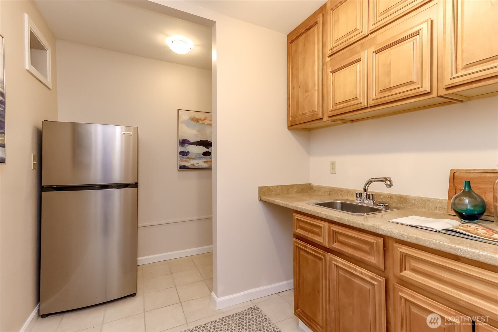 4444 44th Avenue Southwest, Unit 405 Seattle, WA 98116 - Photo 30 of 32 a kitchen with stainless steel appliances granite countertop a refrigerator a stove and a sink