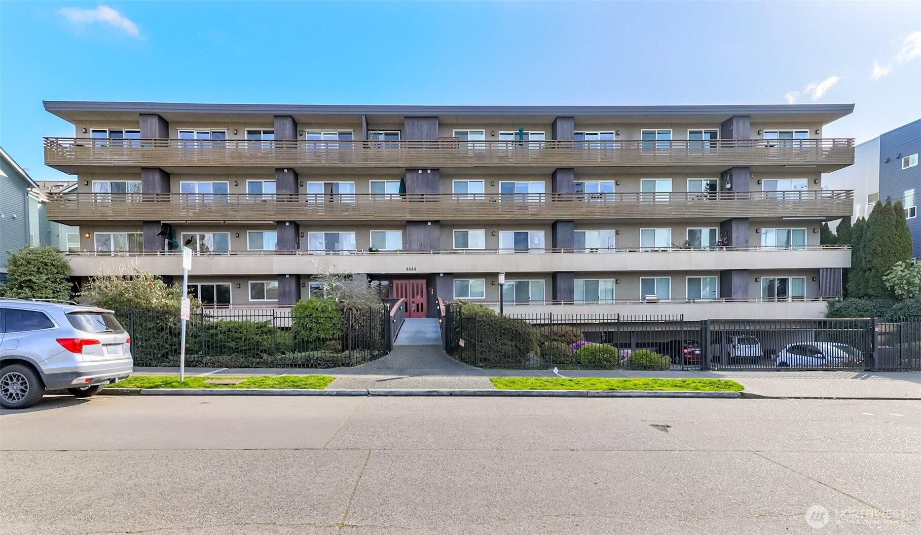 4444 44th Avenue Southwest, Unit 405 Seattle, WA 98116 - Photo 3 of 32 a front view of a building with garden
