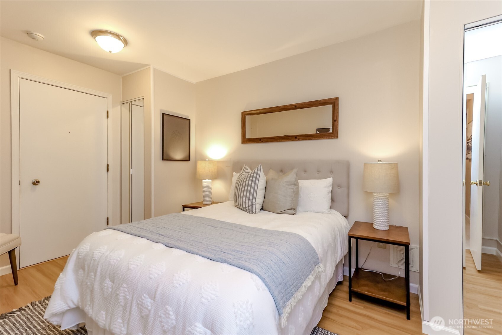 4444 44th Avenue Southwest, Unit 405 Seattle, WA 98116 - Photo 31 of 32 a bedroom with a bed and a painting on the wall