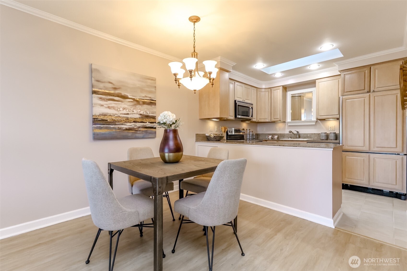 4444 44th Avenue Southwest, Unit 405 Seattle, WA 98116 - Photo 10 of 32 a view of a dining room with furniture a chandelier and wooden floor