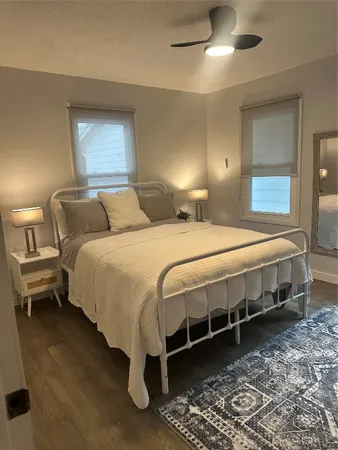 a bedroom with a bed and a chandelier fan