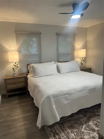 a bedroom with a bed and a lamp