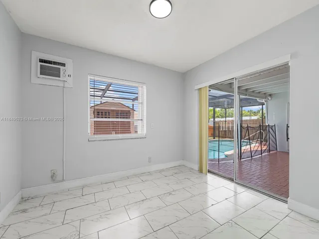 a view of an empty room with glass door