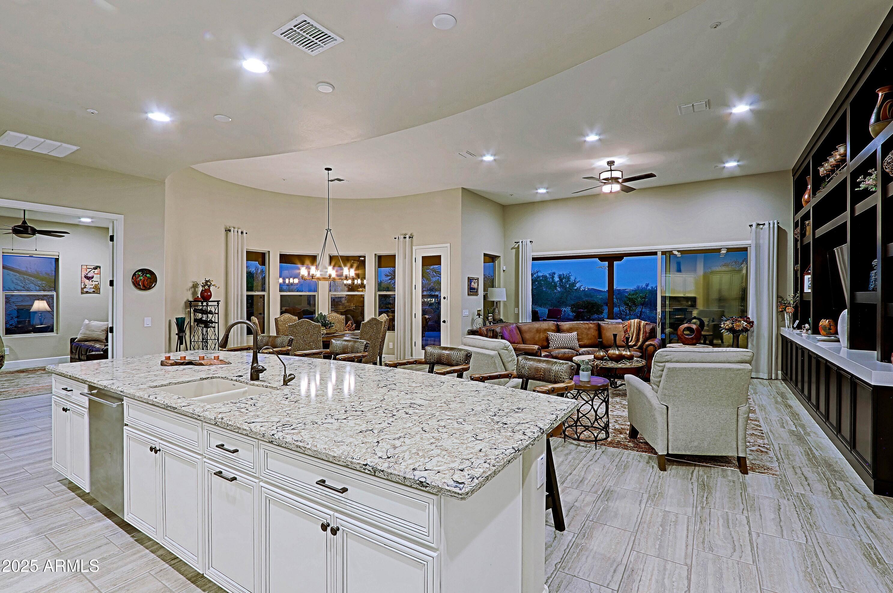 17249 East Fort Verde Road Rio Verde, AZ 85263 - Photo 12 of 48 a kitchen with stainless steel appliances granite countertop a lot of counter space and living room