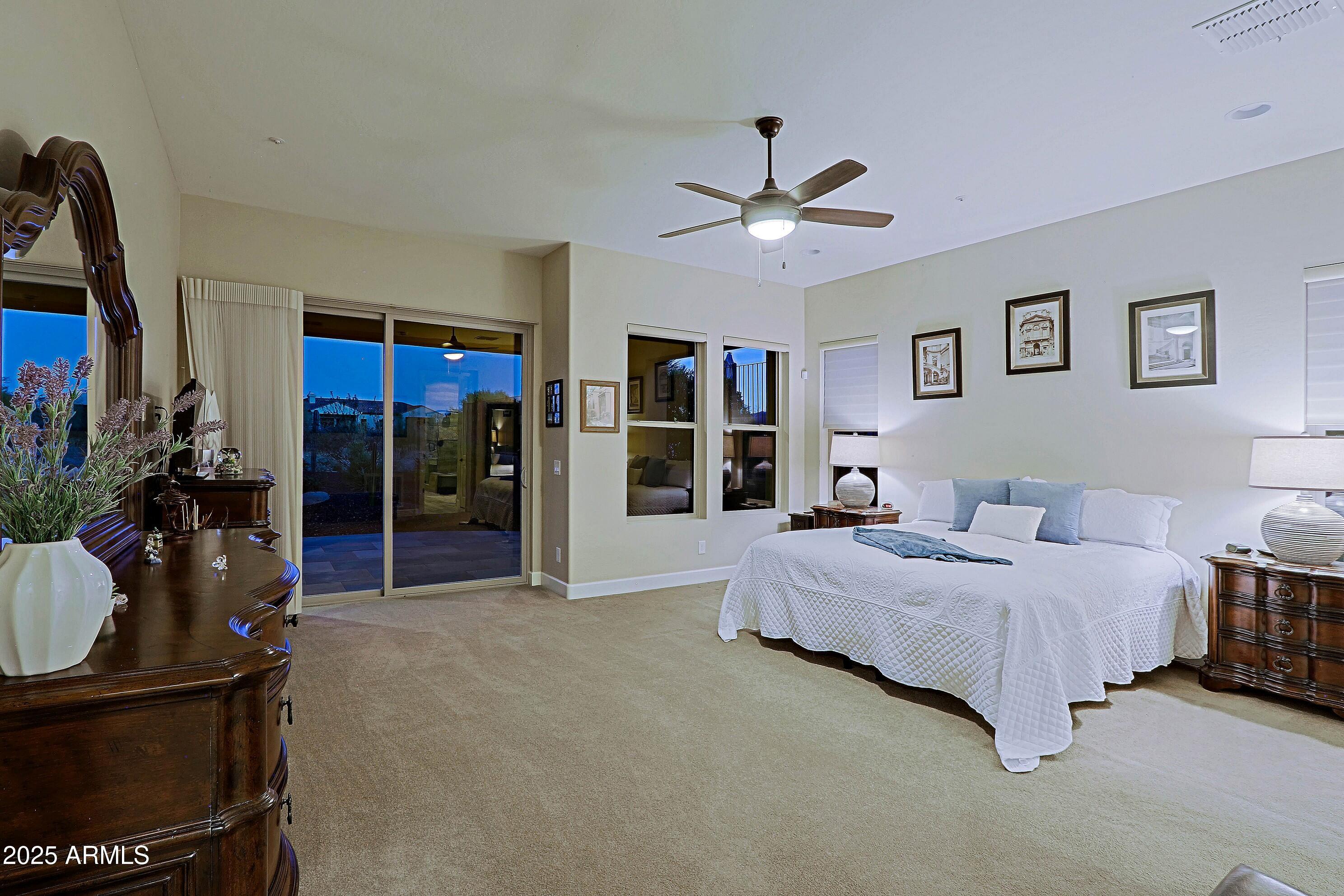 17249 East Fort Verde Road Rio Verde, AZ 85263 - Photo 17 of 48 a spacious bedroom with a bed a window and dresser