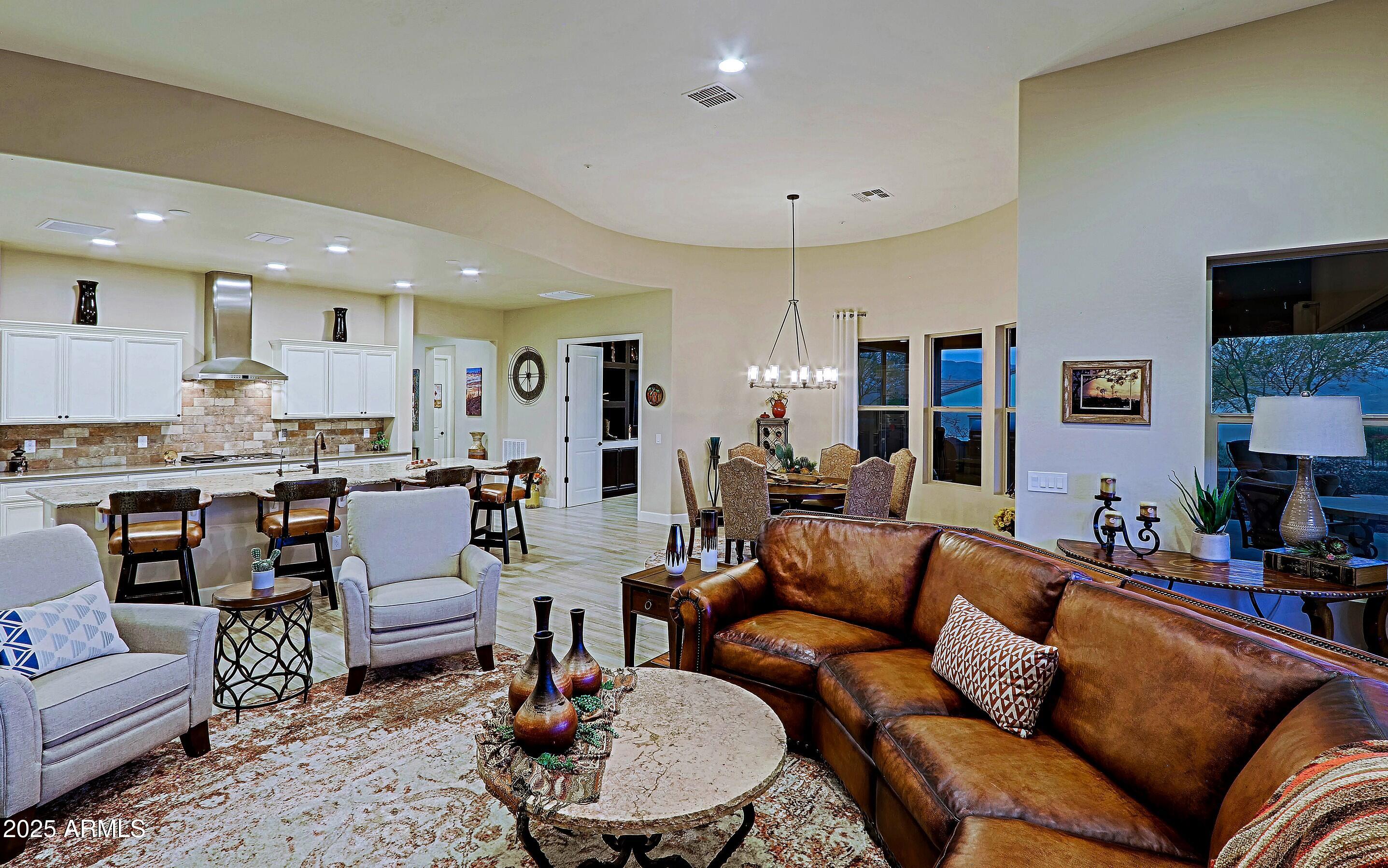 17249 East Fort Verde Road Rio Verde, AZ 85263 - Photo 8 of 48 a living room with furniture kitchen view and a chandelier