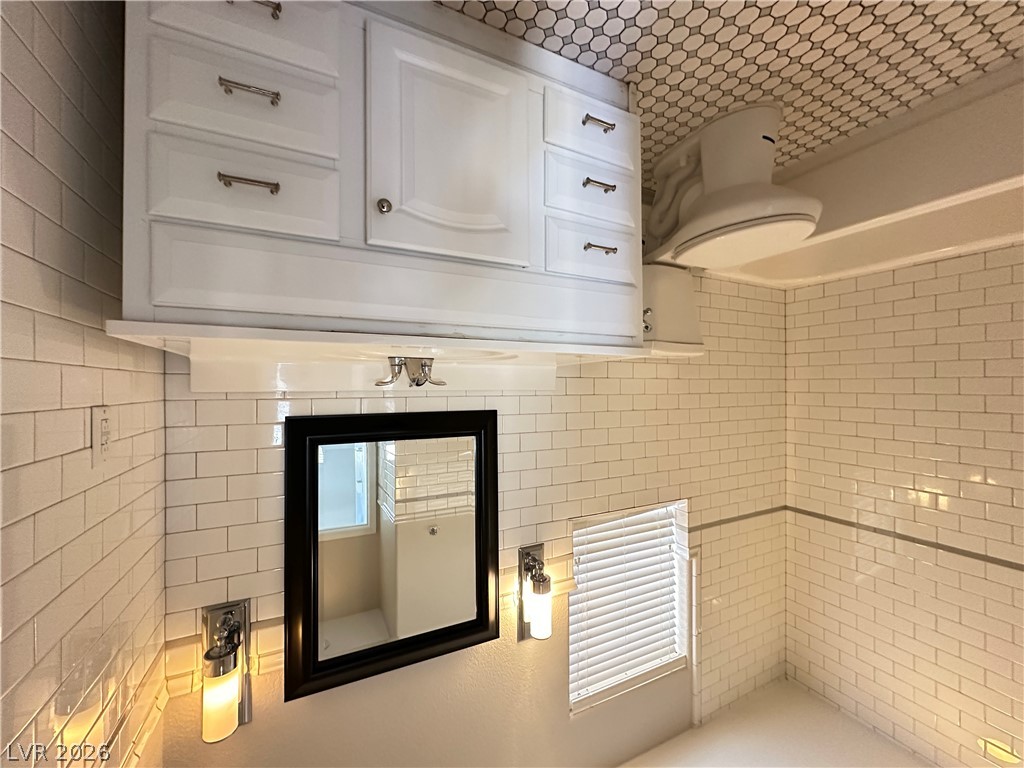10191 Splendor Ridge Avenue Las Vegas, NV 89135 - Photo 11 of 31 Crisp subway tiles encase this tidy bathroom, featuring a practical vanity and charming hex tile flooring.