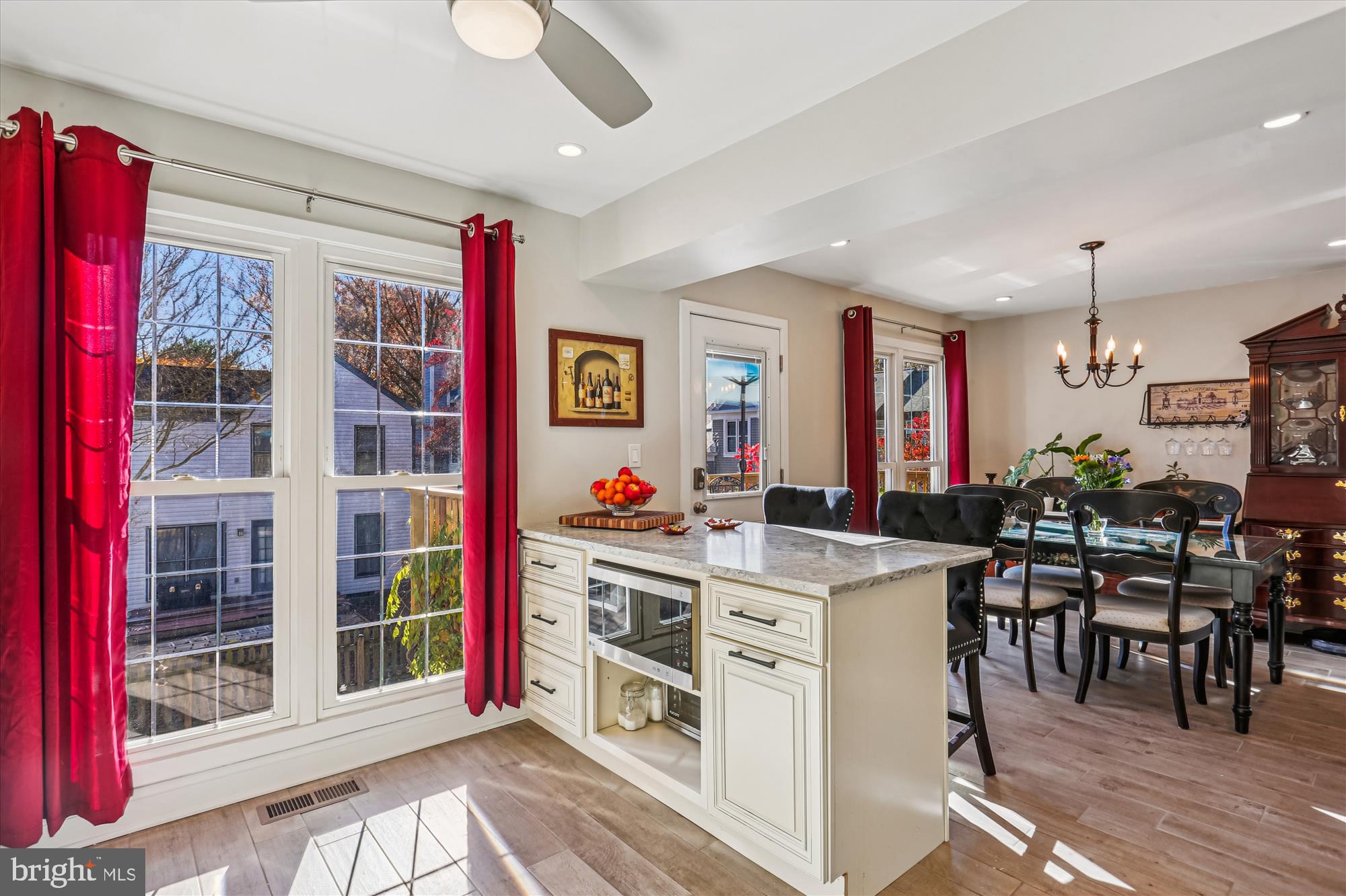 20510 Bargene Way Germantown, MD 20874 - Photo 17 of 97 a view of a kitchen with stainless steel appliances granite countertop a stove and a dining table with wooden floor