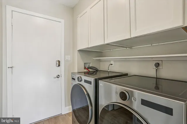 a utility room with sink dryer and washer