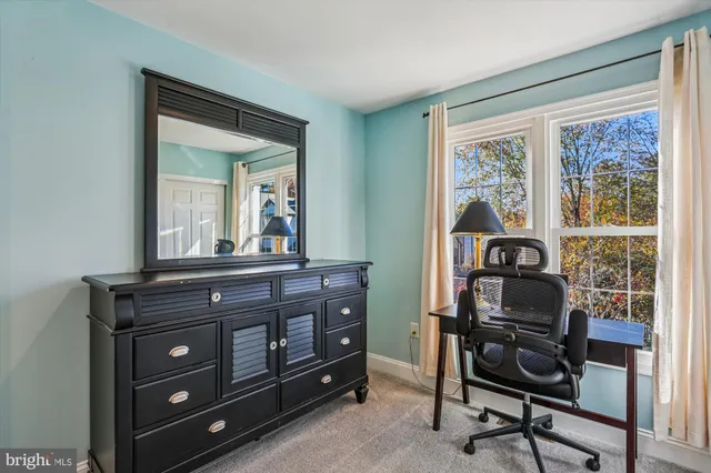 a view of a patio with a table and chairs with wooden floor and fence