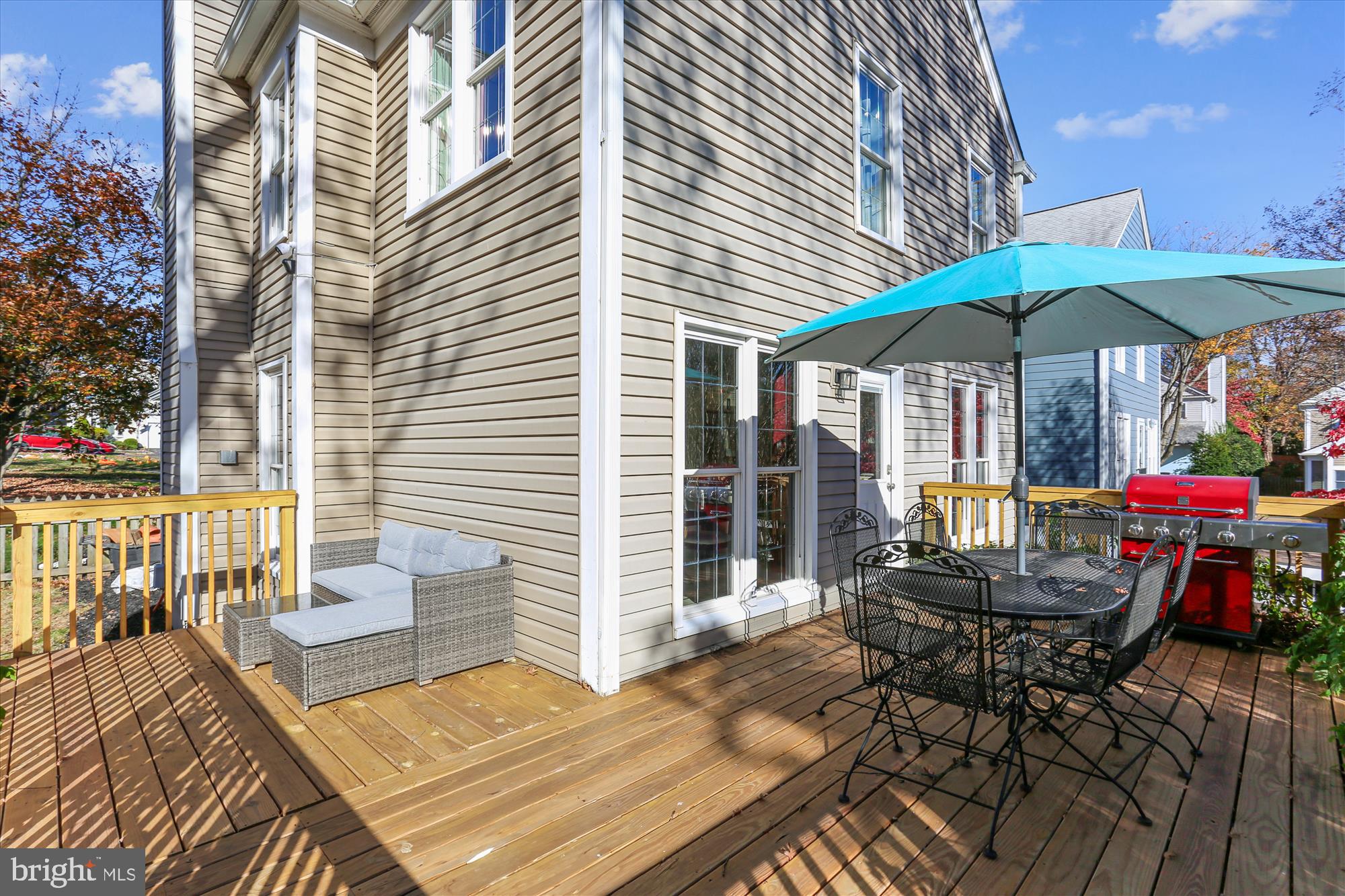 20510 Bargene Way Germantown, MD 20874 - Photo 60 of 97 a view of a patio with a table and chairs under an umbrella