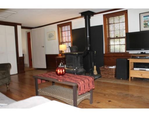 131 Spofford Road Boxford, MA 01921 - Photo 11 of 18 a living room with furniture a flat screen tv and a fireplace