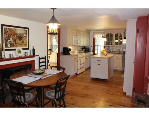 131 Spofford Road Boxford, MA 01921 - Photo 7 of 18 a open dining room with stainless steel appliances kitchen island granite countertop a table chairs and a refrigerator