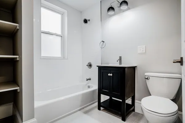 a bathroom with a toilet a sink and bathtub