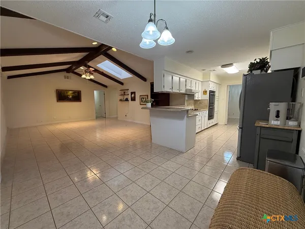 a view of a kitchen with furniture and a kitchen