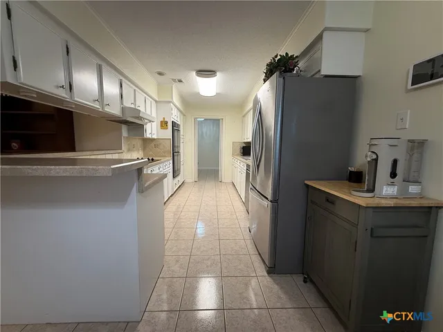 a kitchen with stainless steel appliances a refrigerator and a sink