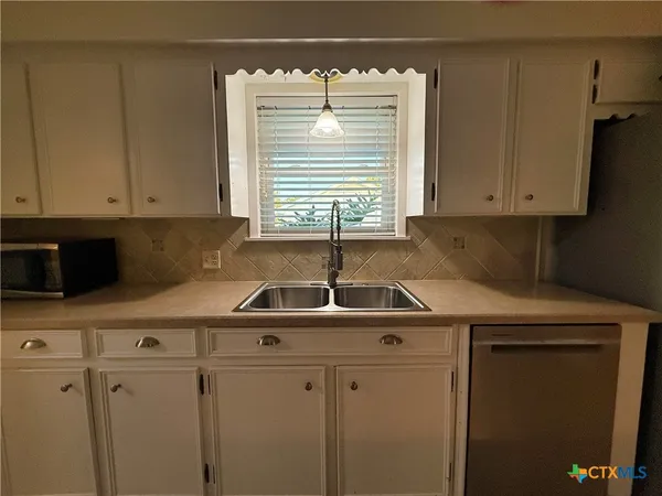 a kitchen with stainless steel appliances granite countertop a sink and a cabinets
