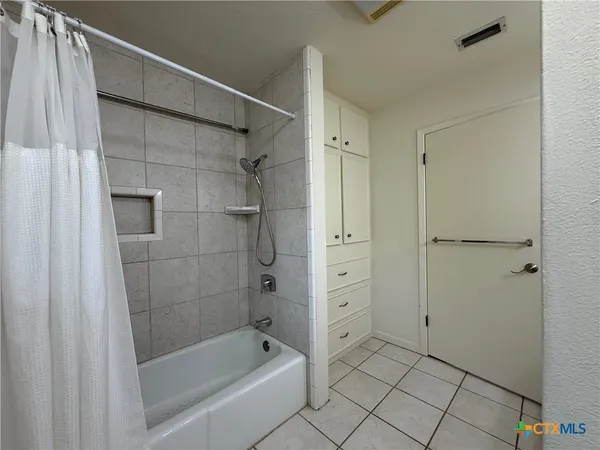 a bathroom with a bathtub and a shower