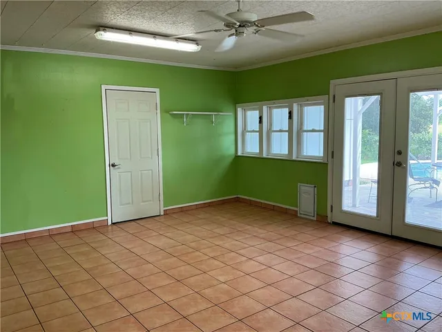 an empty room with entrance and windows