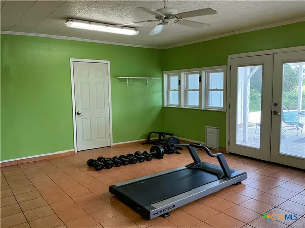 a living room with a bed furniture and a large window
