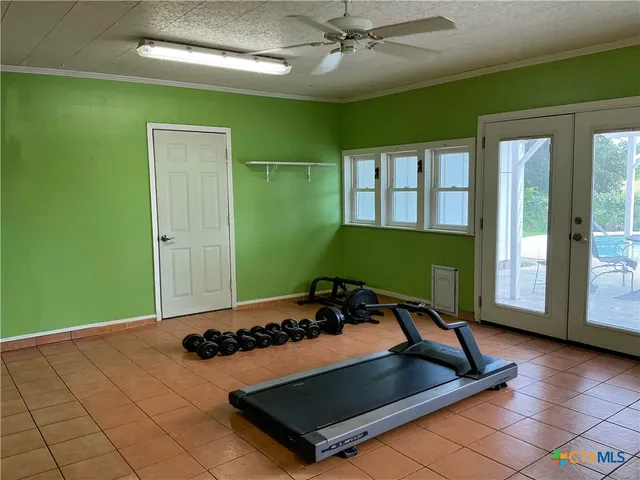 a living room with a bed furniture and a large window